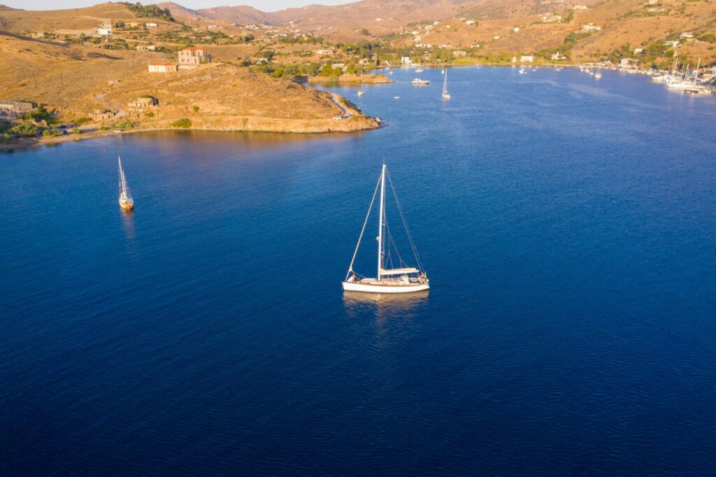 Kea Tzia island, Cyclades, Greece. Aerial drone photo of the bay at sunset time. Vourkari marina and Kokka beach