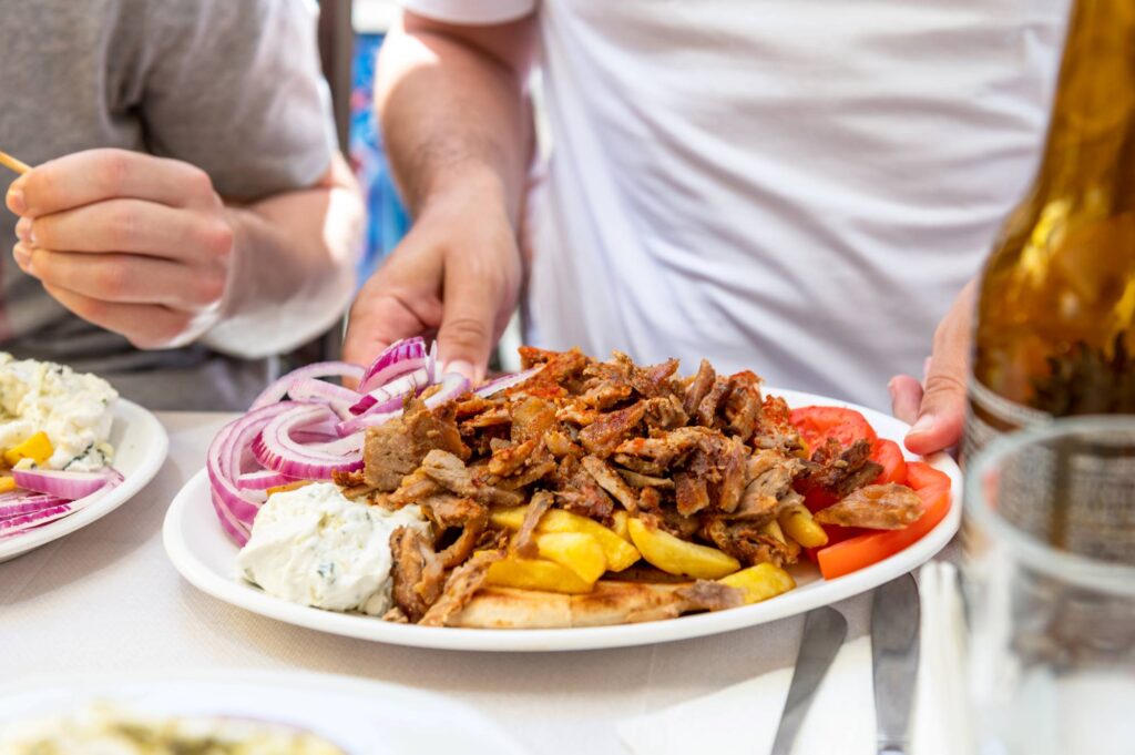 Traditional Greek food served in tavern, made from Kebab Beef Souvlaki, french fries, salad and pita bread