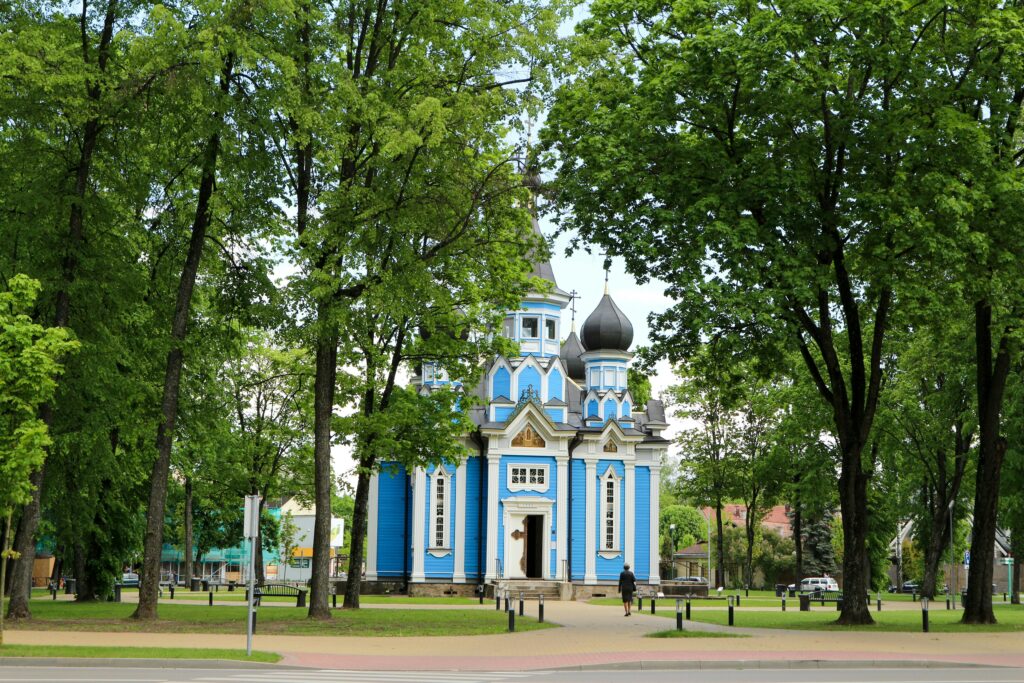 White and Blue Concrete Building Near Green Trees