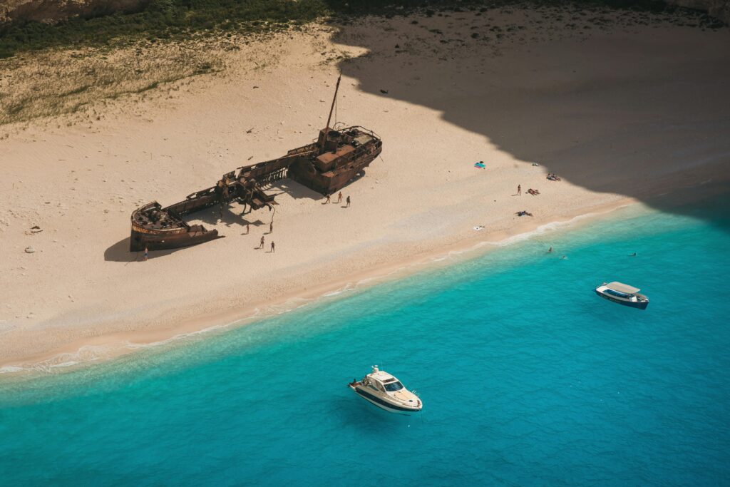 Aerial Photography of Shipwreck on the Sandy Shore of a Beach