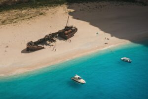 Aerial Photography of Shipwreck on the Sandy Shore of a Beach