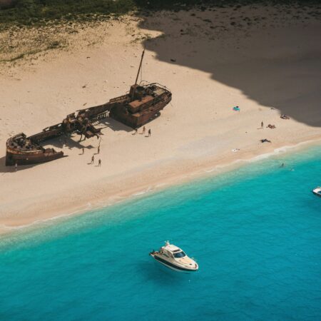 Aerial Photography of Shipwreck on the Sandy Shore of a Beach