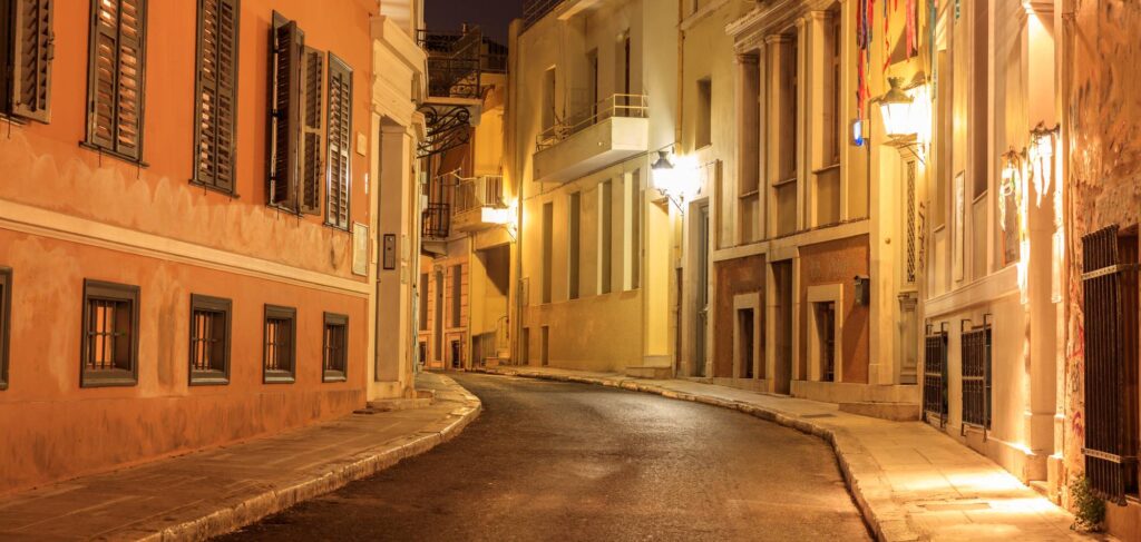 Plaka by night, Athens, traditional buildings at the sides of a street. Architecture in Greece.