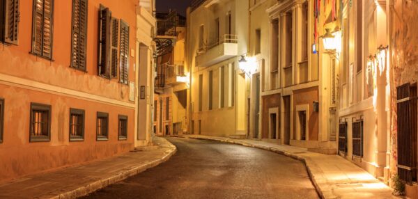 Plaka by night, Athens, traditional buildings at the sides of a street. Architecture in Greece.