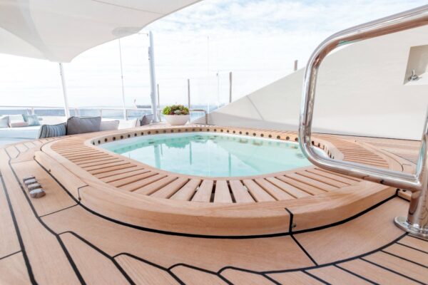 A pool on a yacht with a cloudy sky in the background