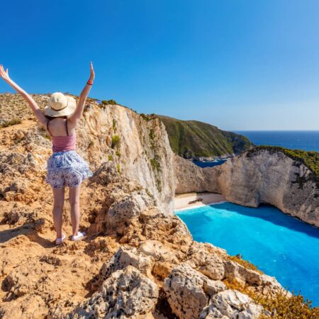 Woman tourist in Zakynthos, Greece admiring the Navagio beach